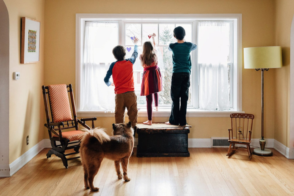 The Ferrazzano kids hang paper hearts in their Madison home.