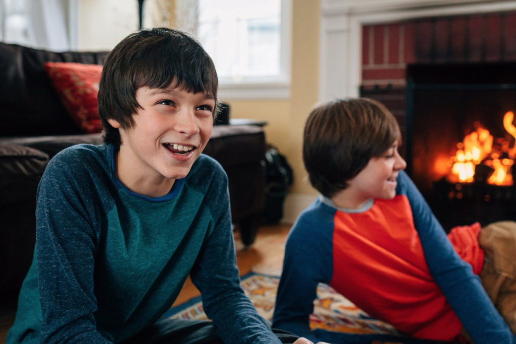 Aeneas and Lorenzo Ferrazzano play cards at home with their family.