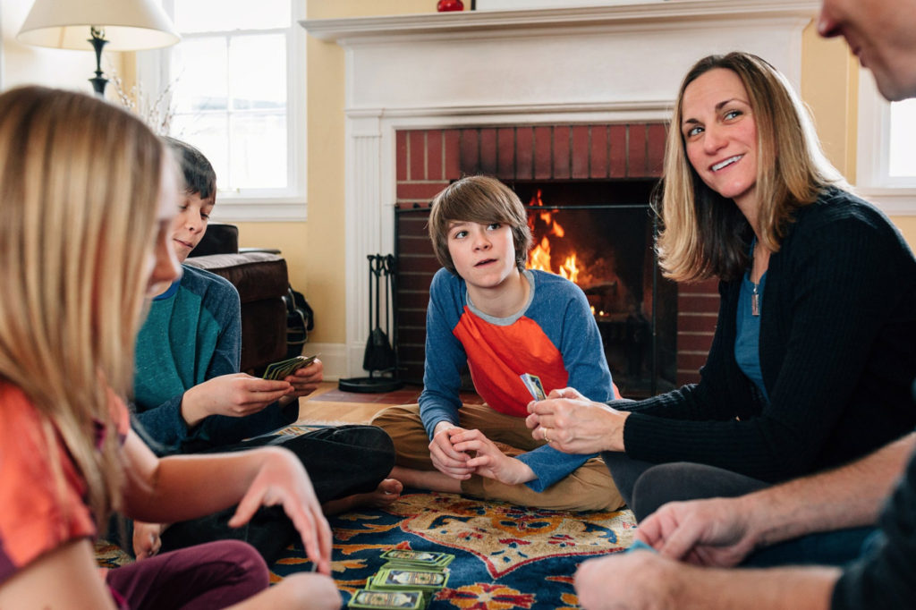 The Ferrazzano family plays cards at home.