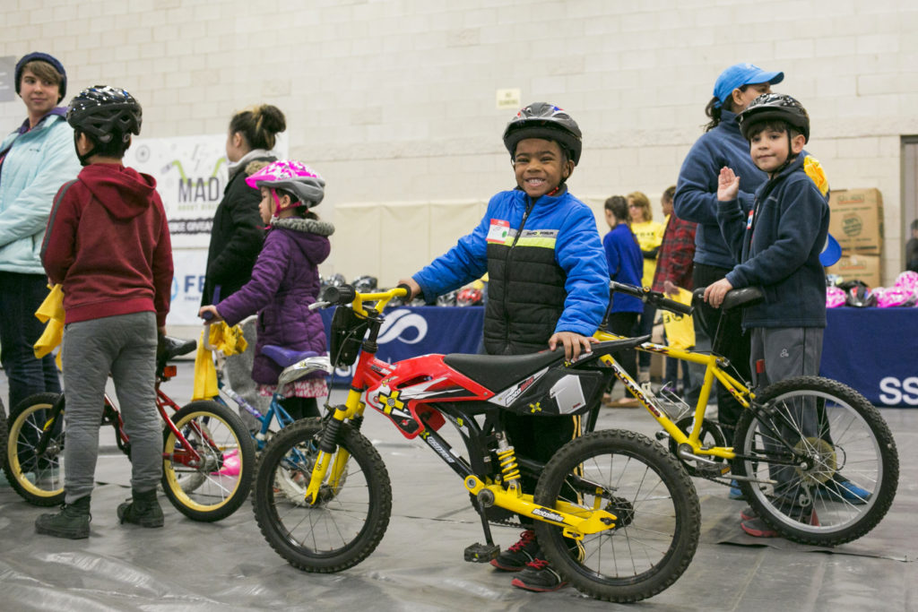 A boy gets a new bike from Free Bikes 4 Kidz Madison.