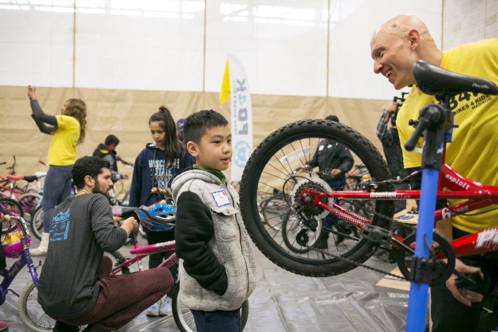 A boy receives a bike from Free Bikes 4 Kidz Madison.