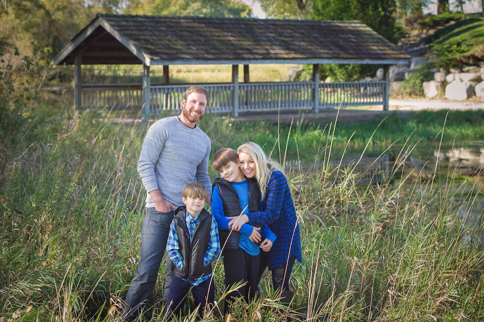 Enna Doyle and her boyfriend and two sons stand in a field.