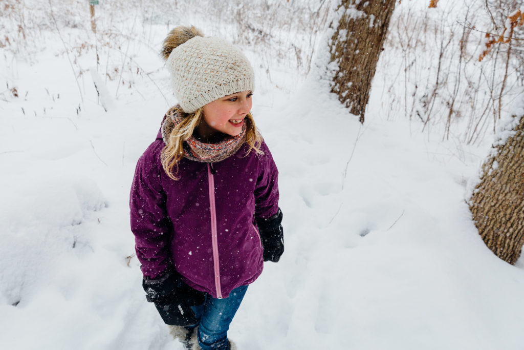 A girl walks in the snow.