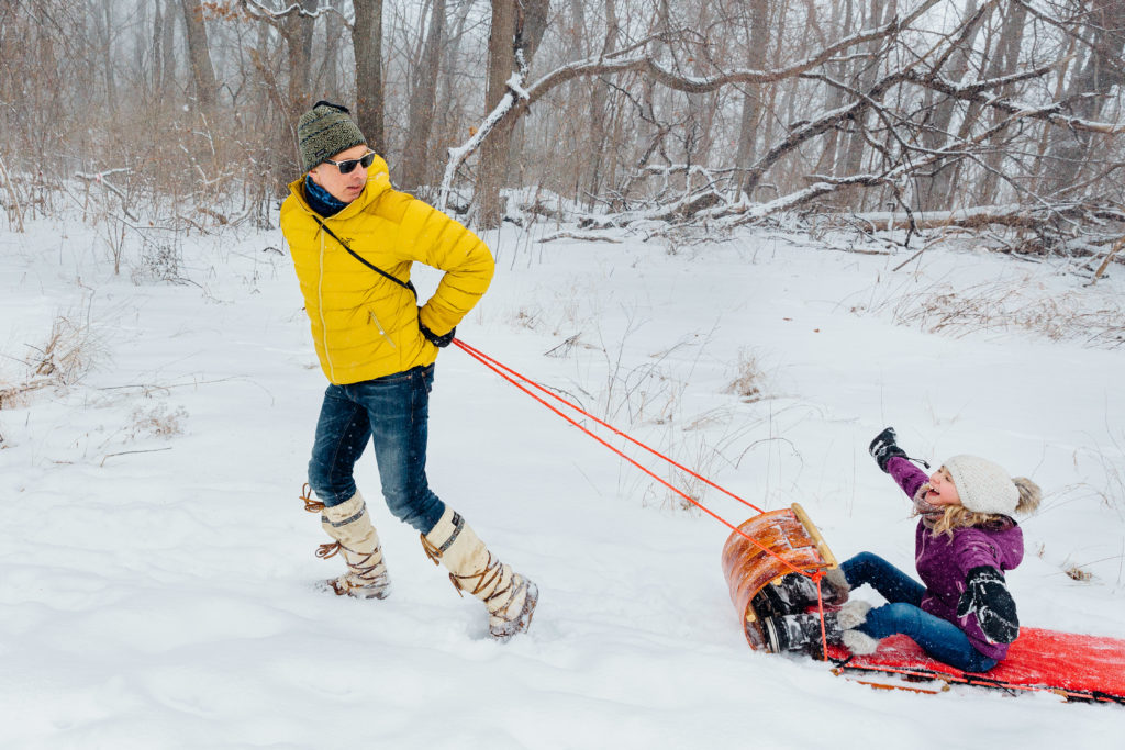 Troy Kattreh pulls his daughter on a tobbogan.