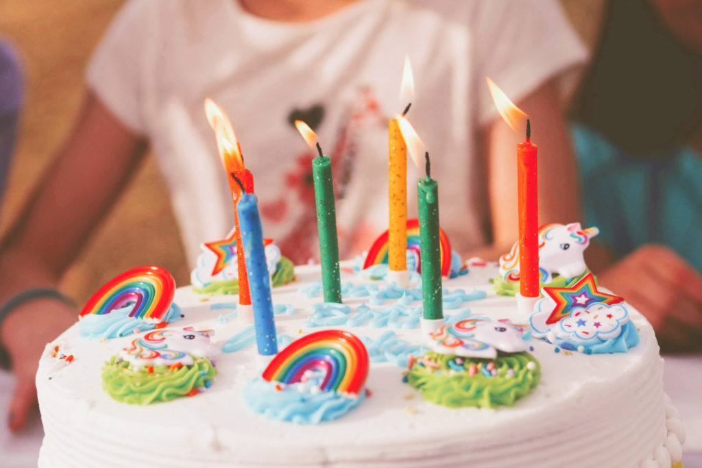 A girl with a birthday cake.