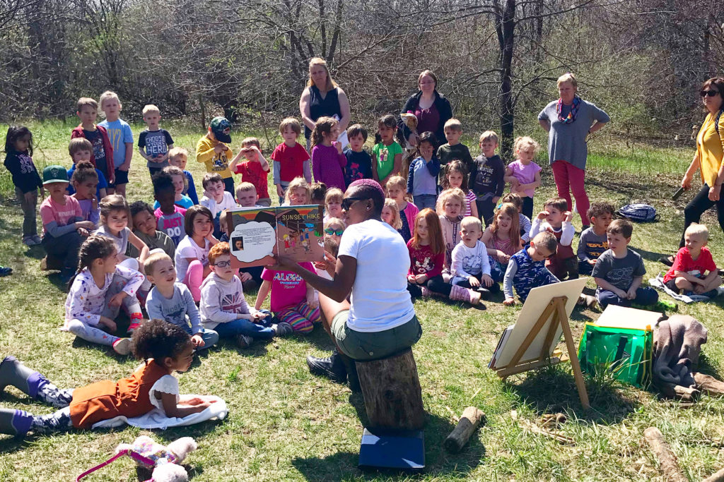 Dineo Dowd reading her book Sunset Hike to a group of children.