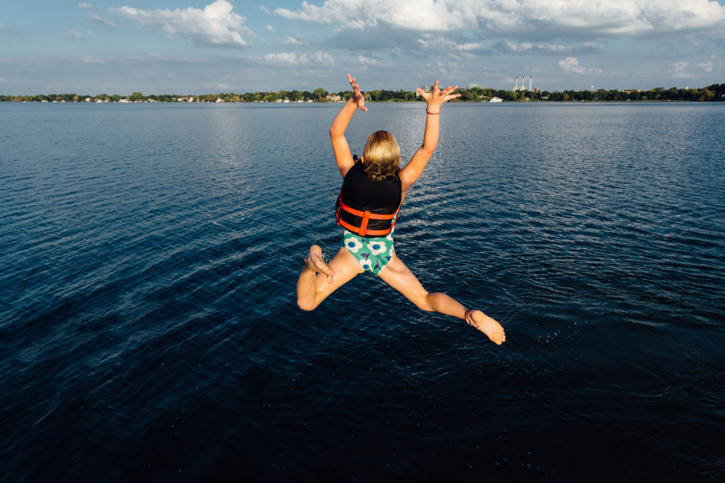 Reece Parsons jumps off her family's sailboat into Lake Mendota.