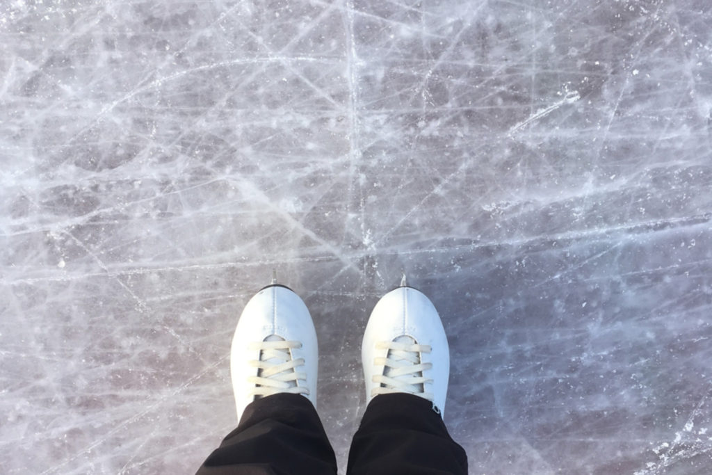 Ice skates on a frozen rink.