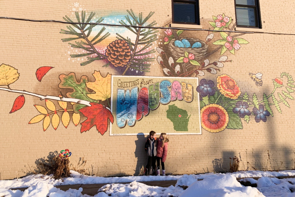 Kids by a mural in Wausau, Wisconsin.