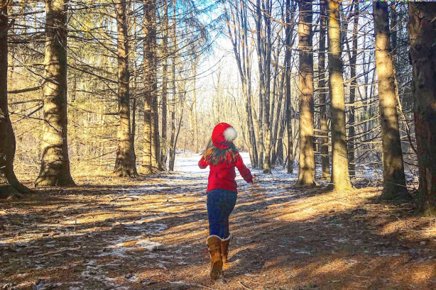 A girl walking in the woods.