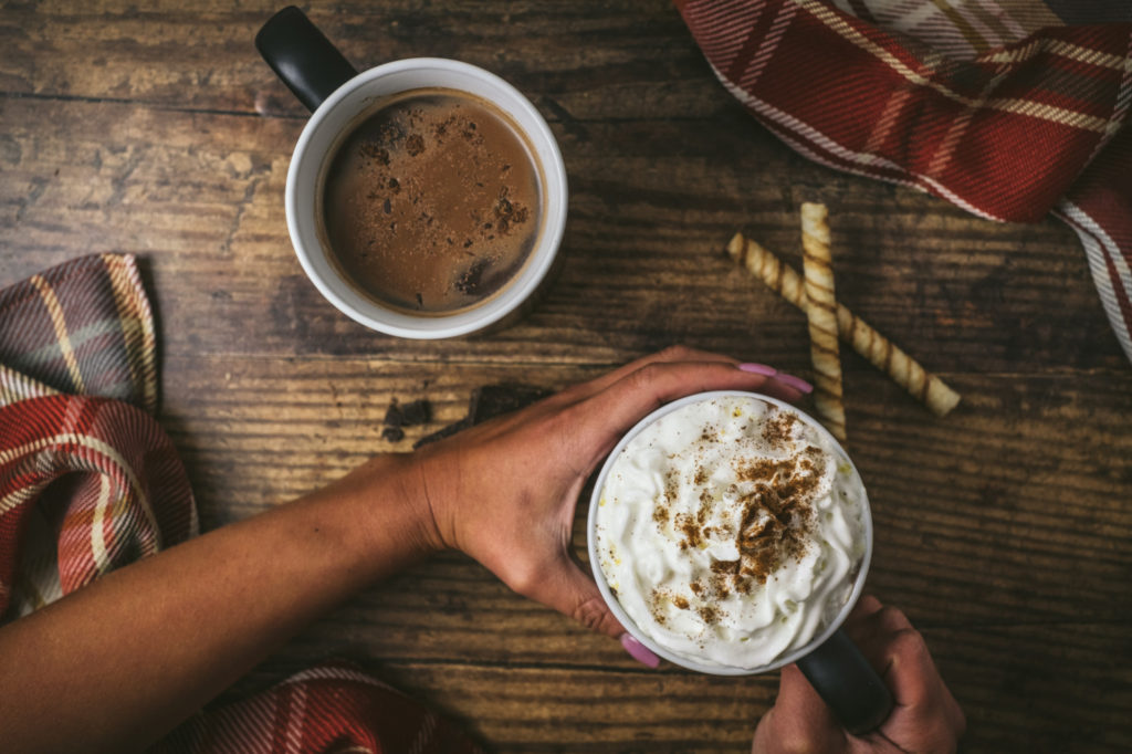 Hands hold a cup of hot chocolate.