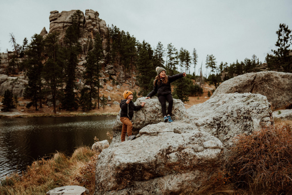 Two children exploring rocky hills in South Dakota.