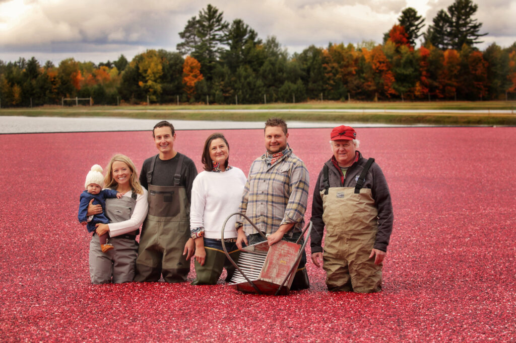 The Bartling family stands in a cranberry field.