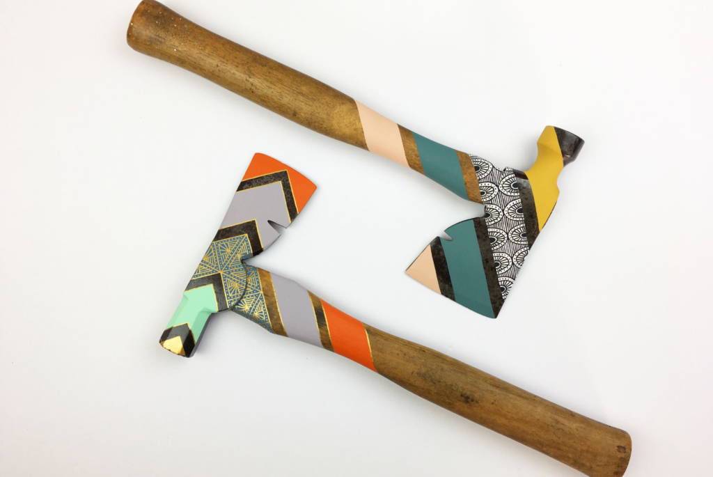 Two painted hatchets by Milwaukee artist Cassandra Smith.
