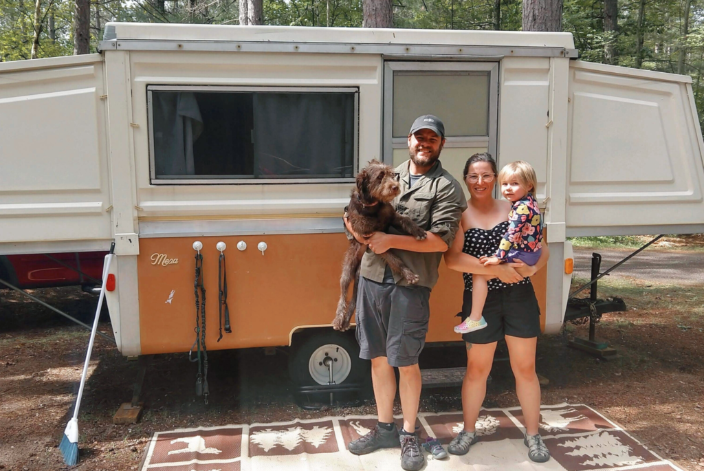 The Kulick family in front of their pop-up camper.