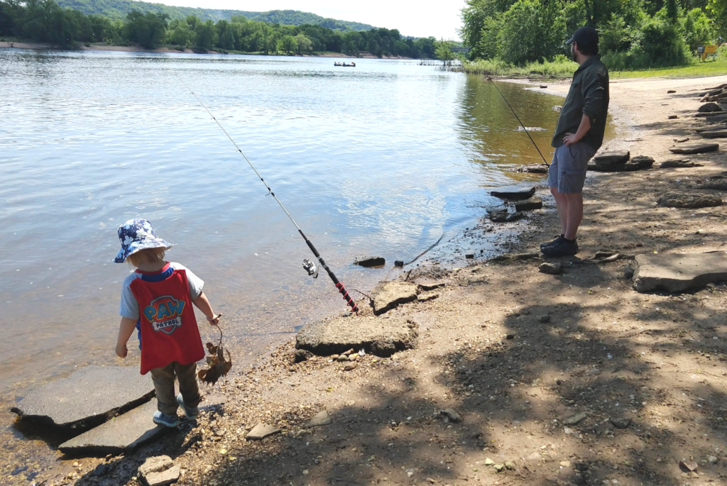Max Kulick fishes with his daughter on a Wisconsin shoreline.