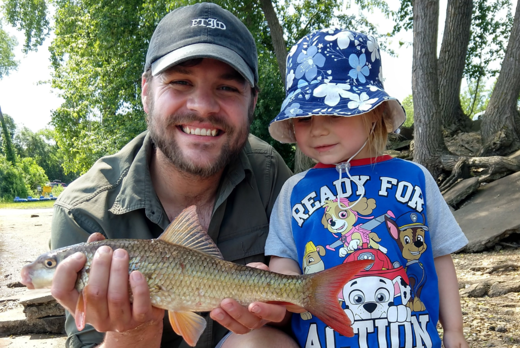 Max Kulick holds a fish that he caught with his daughter at a Wisconsin lake.